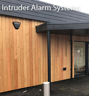 A D-TECT intruder alarm siren on the exterior of a commercial building